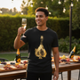 Man toasting at outdoor party wearing ace of spades champagne camiseta, perfect for foodies and cocktail lovers