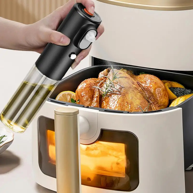 Person using an oil sprayer to cook a roasted chicken in an air fryer.