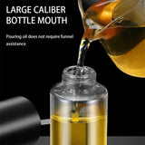 Clear bottle with large caliber mouth being filled with oil from a funnel against a black background.
