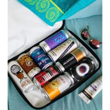 Set of spray paint cans in a case with a teal background