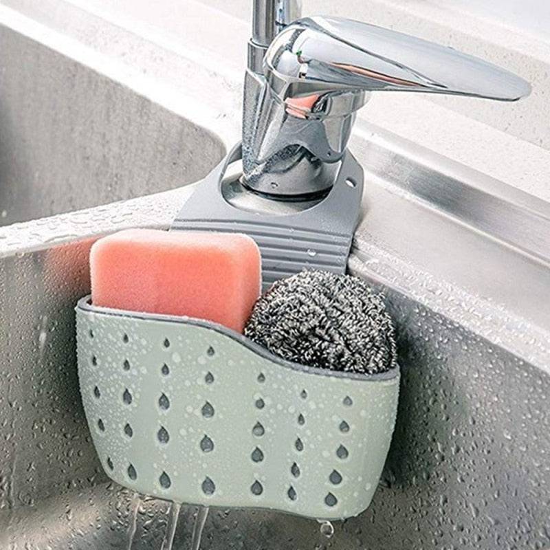 Adjustable plastic storage drain basket sink holder with drainage holes, holding sponge and scrubber.