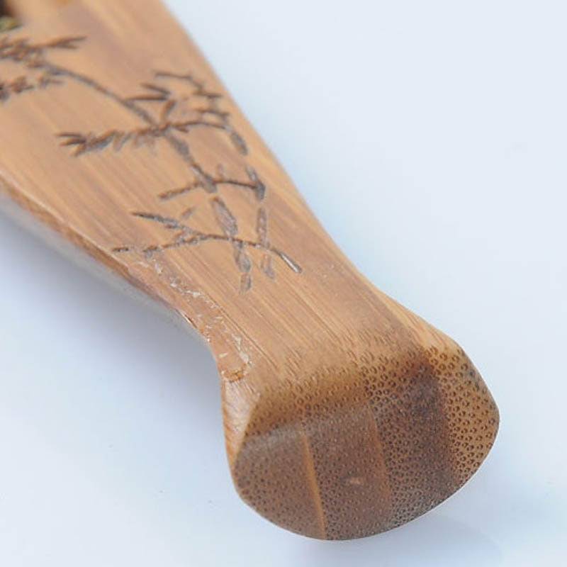 Bamboo fish-shaped tea spoon shovel with intricate engraving.
