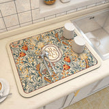 Large kitchen super absorbent draining drying mat on countertop with cups and spoons, decorative floral pattern.