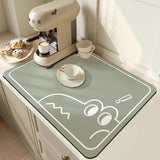 Large kitchen super absorbent draining drying mat on countertop with coffee machine and pastries.