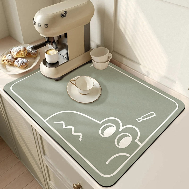 Large kitchen super absorbent draining drying mat on countertop with coffee machine and pastries.