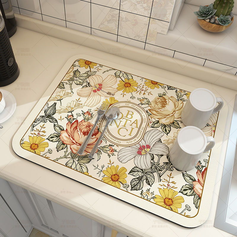 Large kitchen super absorbent draining drying mat with floral design on a countertop.