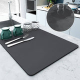 Large kitchen super absorbent draining drying mat in use, showing water absorption and dish drying on countertop.