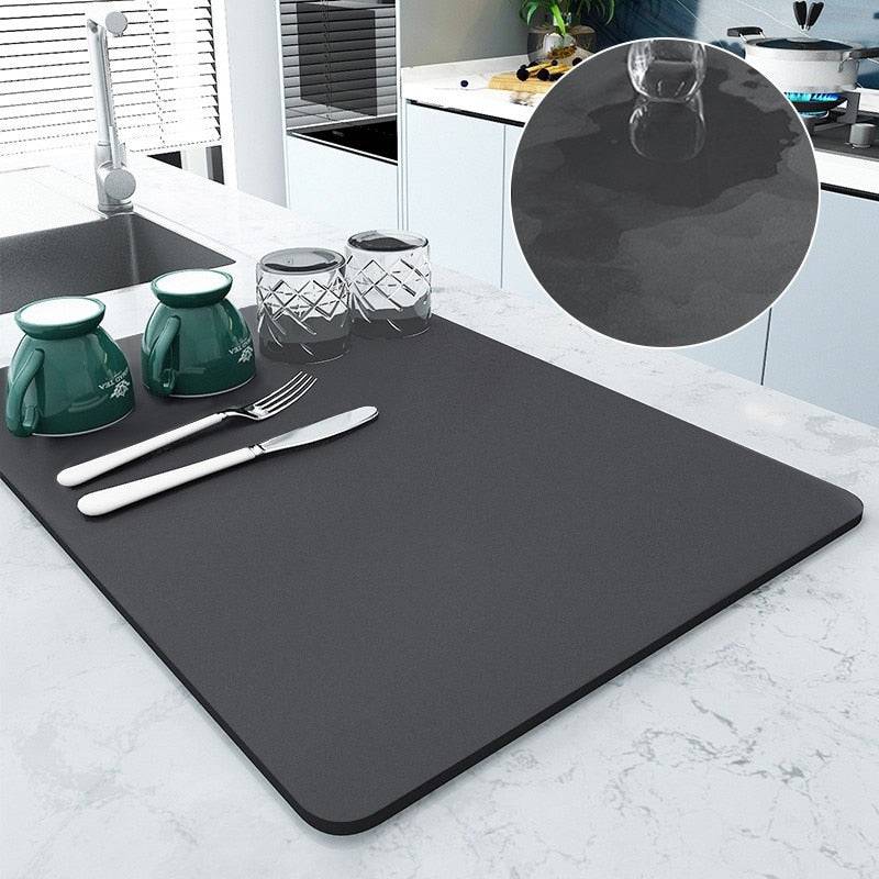 Large kitchen super absorbent draining drying mat in use, showing water absorption and dish drying on countertop.