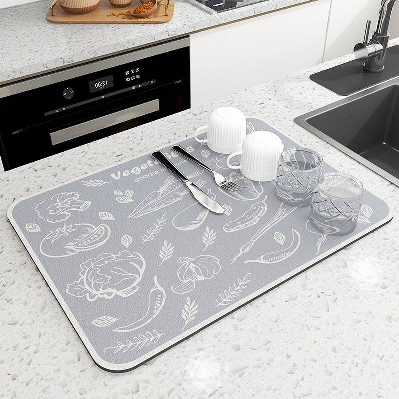 Large kitchen super absorbent draining drying mat on countertop with dishes and utensils