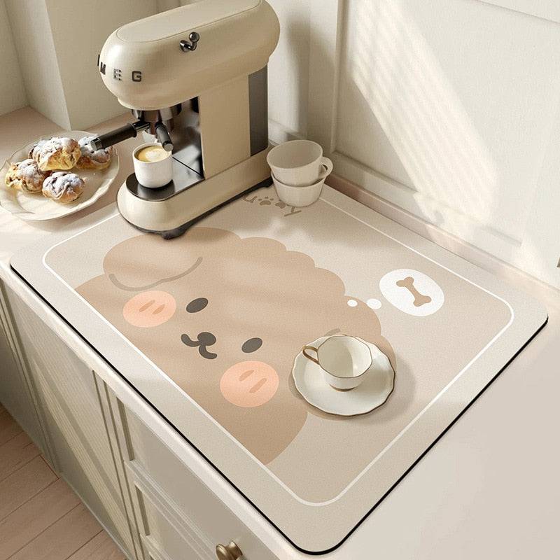 Large kitchen super absorbent draining drying mat on countertop with coffee machine and pastry.