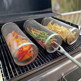 Outdoor stainless steel grilling baskets filled with vegetables on a BBQ grill.