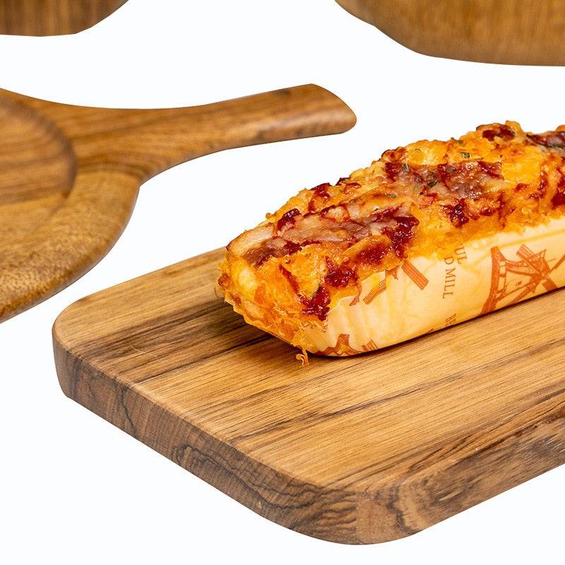 Wooden chopping board with bread, ideal for versatile kitchen tasks and stylish decor.