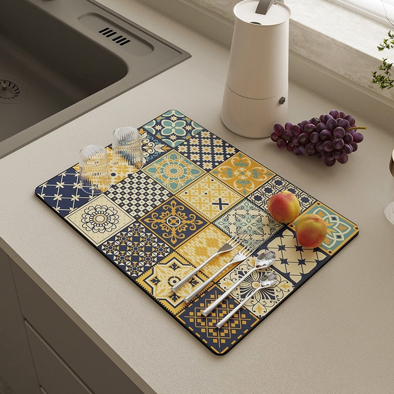 Kitchen dish drying mat absorbent drain pad with vibrant patterns on countertop.