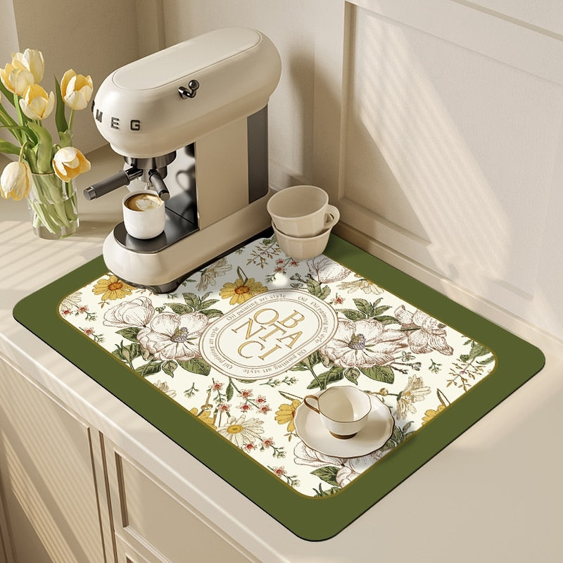 Kitchen dish drying mat with absorbent drain pad near coffee machine on countertop.
