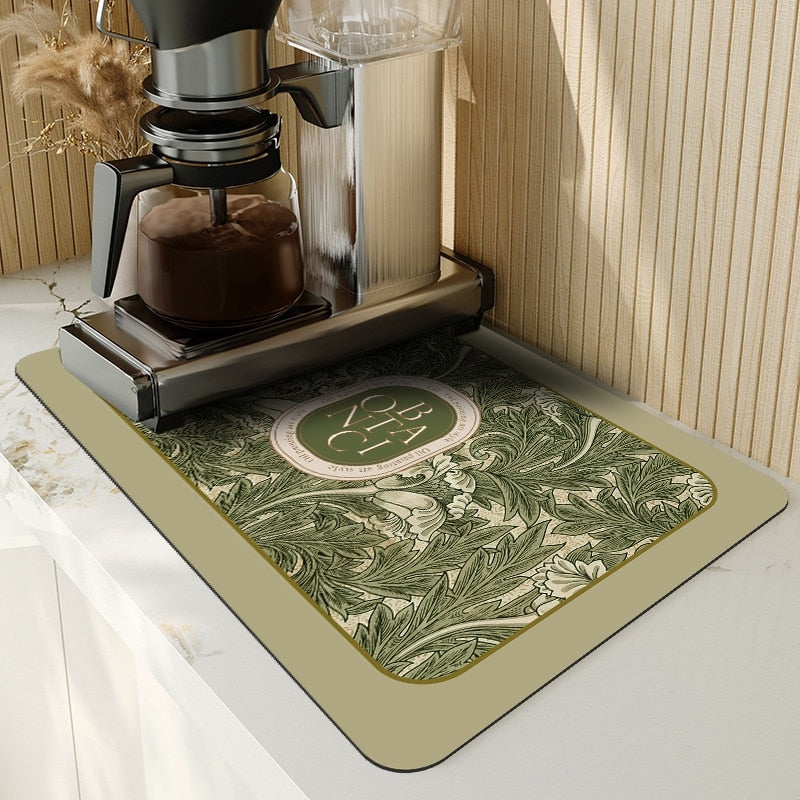 Absorbent kitchen dish drying mat with floral design under coffee machine.