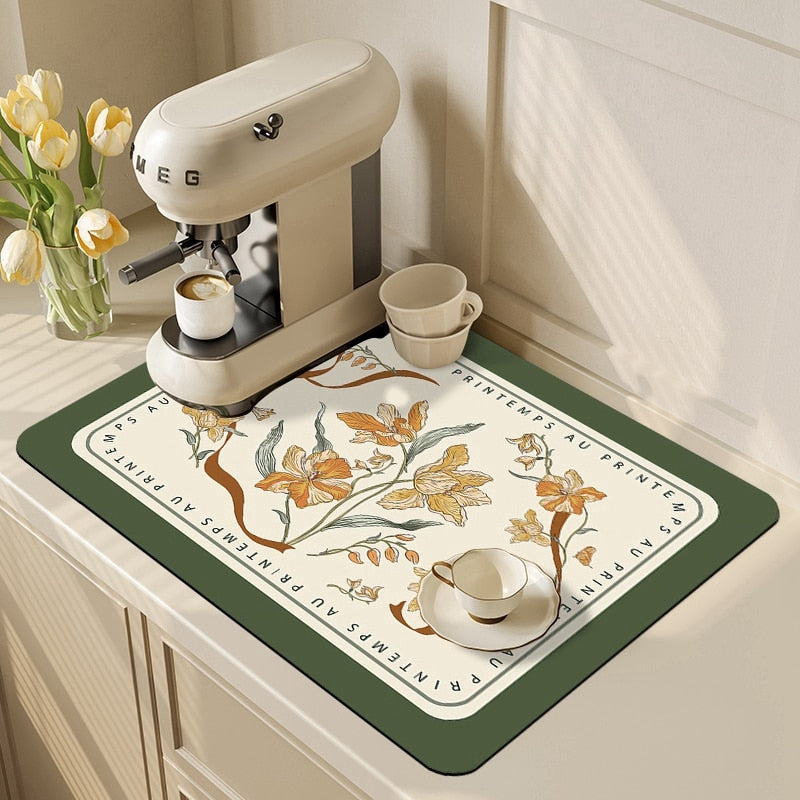 Kitchen dish drying mat with floral design, placed under a coffee machine, showcasing its absorbent properties and stylish look.