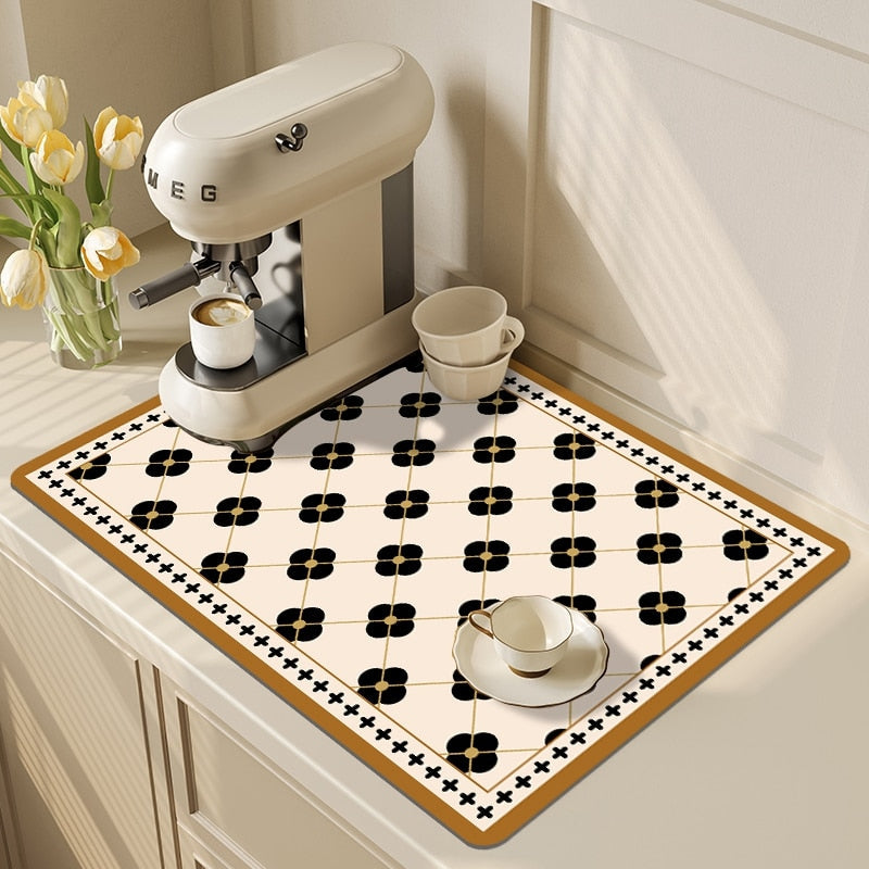 Absorbent kitchen dish drying mat with a coffee cup and machine on a countertop.