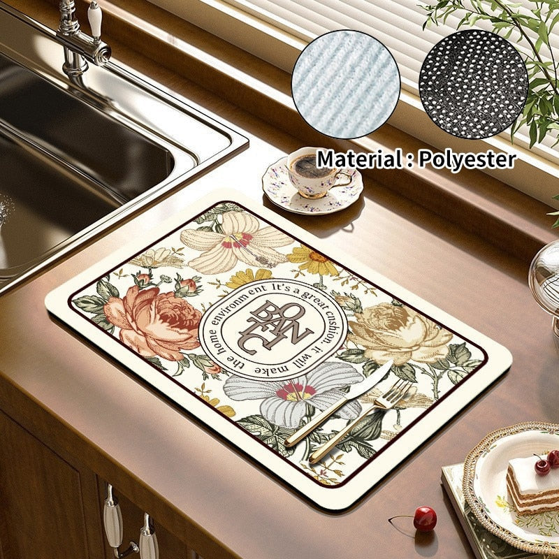 Floral kitchen dish drying mat on counter near sink, made of absorbent polyester.
