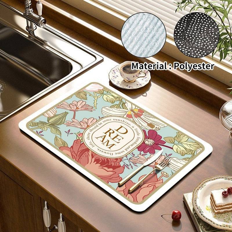 Kitchen dish drying mat on countertop with floral design, made of absorbent polyester material, beside a sink.