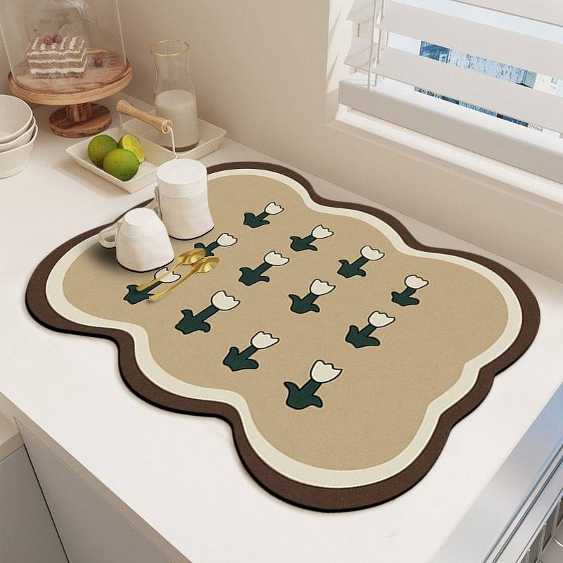 Kitchen dish drying mat with decorative pattern on countertop, absorbent and durable.