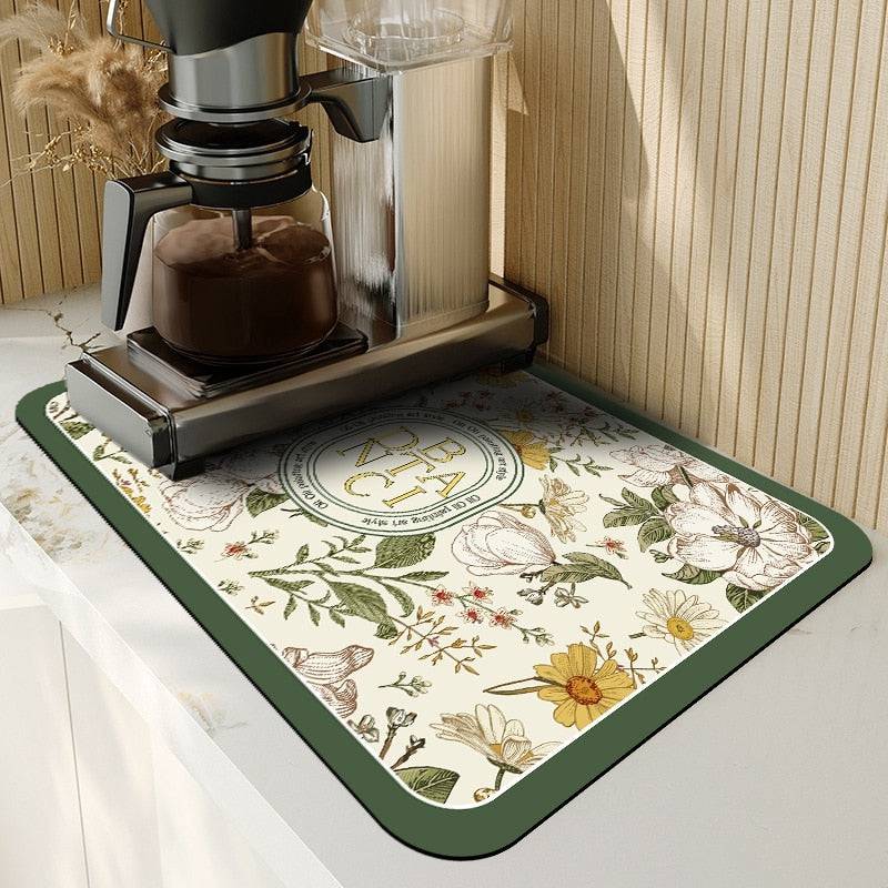 Absorbent floral kitchen dish drying mat under coffee machine.
