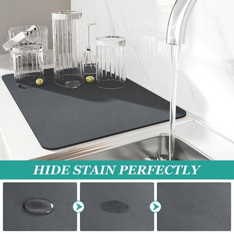 Super absorbent drainer mat on a countertop with glasses, prevents water splashes and keeps surfaces clean.