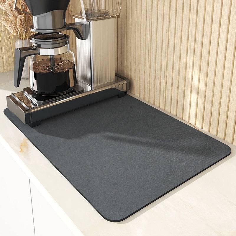 Super absorbent drainer mat under coffee maker on kitchen counter.