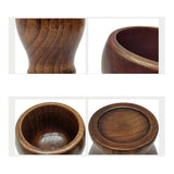 Bamboo wooden mortar and pestle set for grinding spices, close-up view.