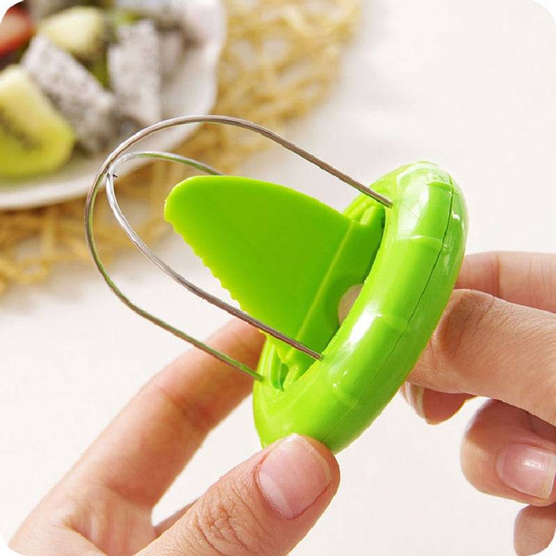 Green Kiwi Cutter Kitchen Detachable Creative Fruit Peeler in use.