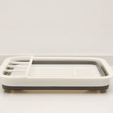 Foldable dish rack kitchen drainer tool with eco-friendly material, collapsible design, and separate utensil area.