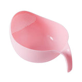 Pink rice washer and quinoa strainer with handle for cleaning veggies and fruit.