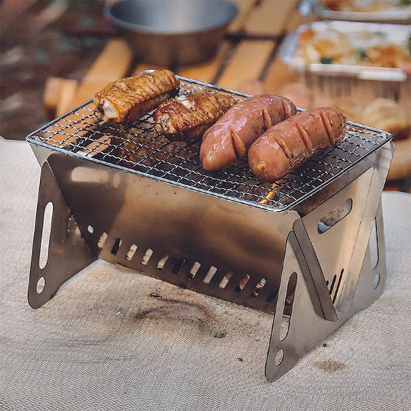 Multifunction portable folding BBQ grill with food cooking on stainless steel surface.