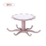 Rotatable kitchen cabinet organizer hook in pink with multiple arms for hanging kitchen utensils.