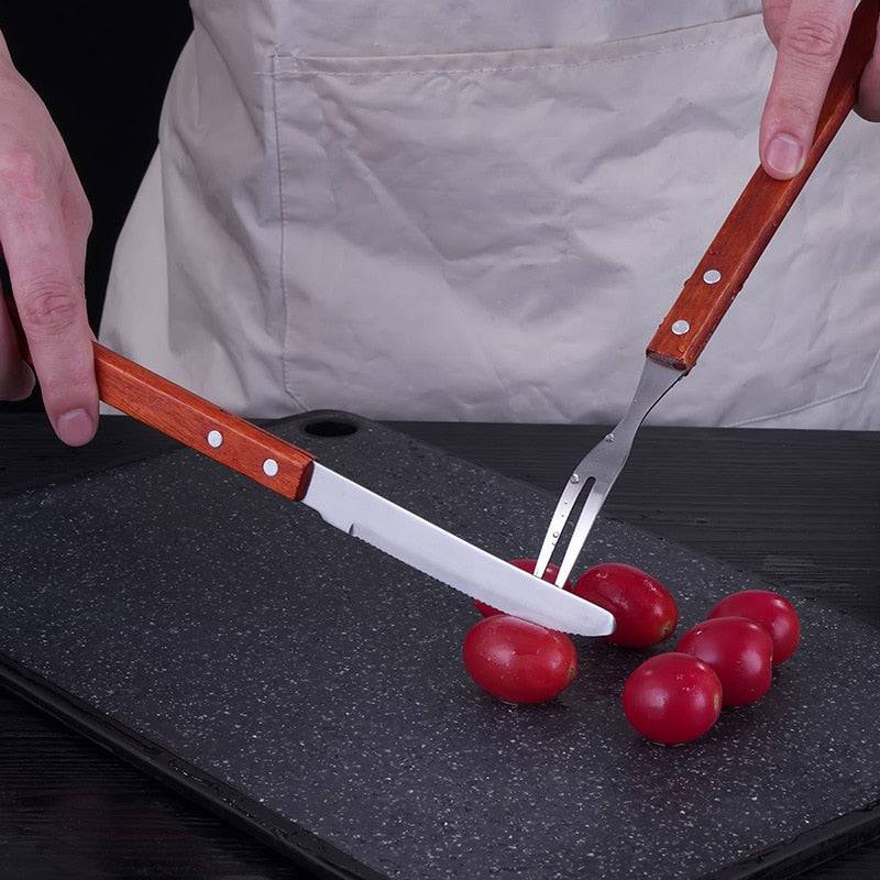Stainless steel roast lamb knife and fork set for BBQ.