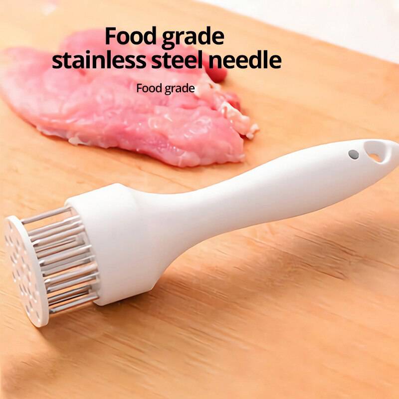 Stainless steel meat tenderizer needle on cutting board with raw meat.