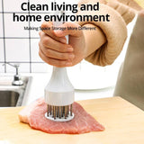 Stainless steel tender meat needle tenderizing a pork chop in the kitchen.