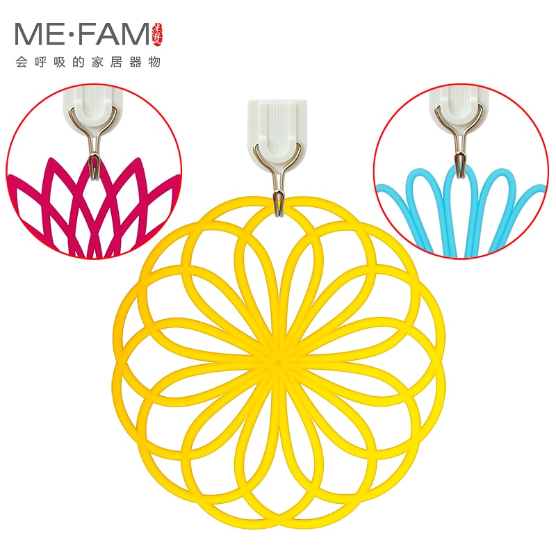 Silicone trivet mat with geometric flower design, durable and heat-resistant, in yellow, rose, and blue colors.