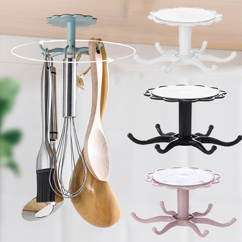 Wall-mounted kitchen flower rotary hook storage rack in black, white, and pink for hanging kitchenware.