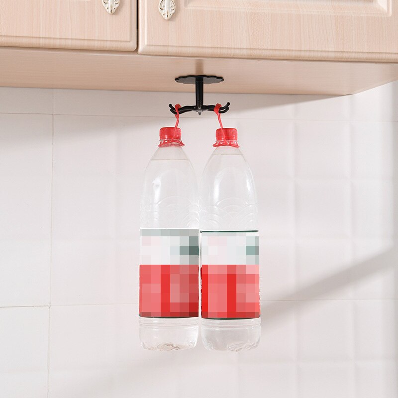 Wall mounted kitchenware storage rack with rotary hook hanging under cabinet, holding two water bottles.