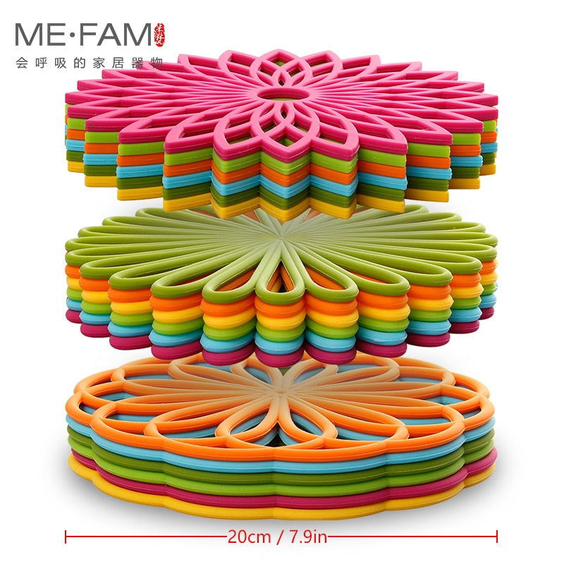Colorful silicone trivet mats in geometric flower design, durable and heat-resistant, ideal for kitchen decor and surface protection.