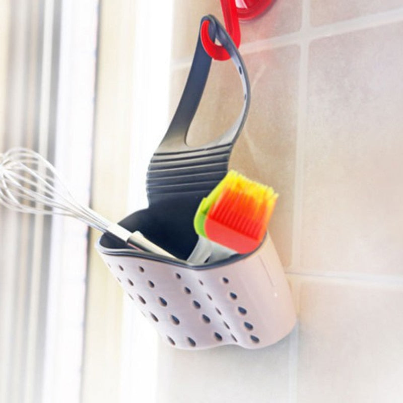 Adjustable storage drain basket sink holder for kitchen utensils.