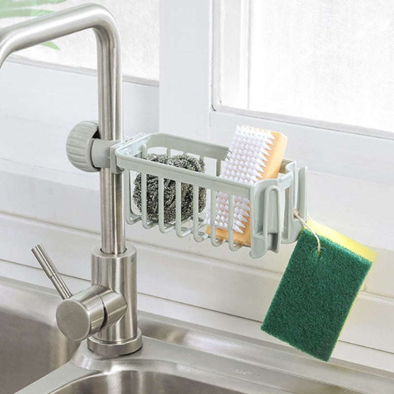 Sink sponge soap cloth drain rack storage organizer attached to kitchen faucet.