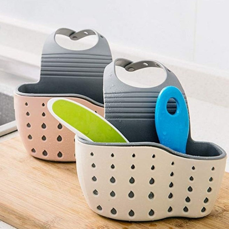 Adjustable storage drain basket sink holder with liquid drainage holes for kitchen organization.