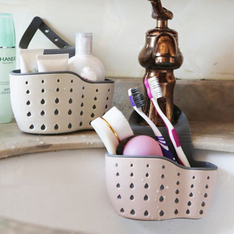Adjustable storage drain basket sink holder with holes for drainage and organizing kitchen or bathroom items.