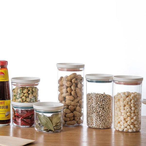Transparent food canisters with sealed rings for kitchen storage.