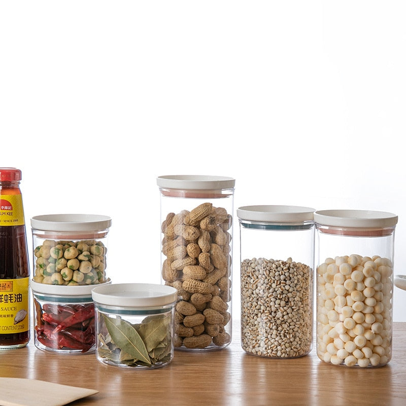 Transparent food canisters with sealed rings for kitchen storage.