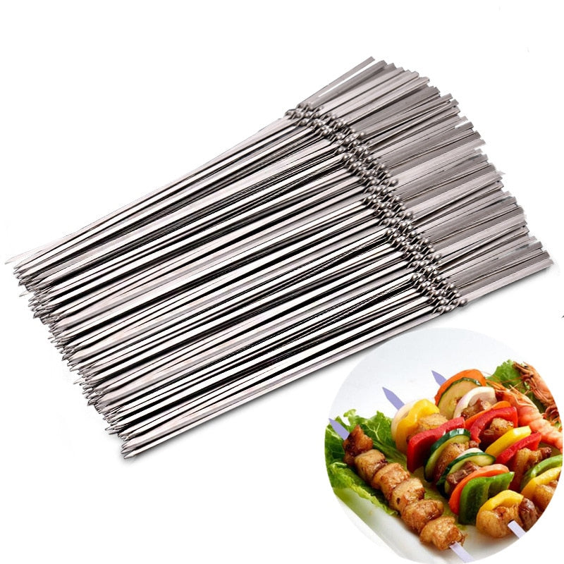 Stainless steel barbecue skewers and storage tube with kebabs on a plate.