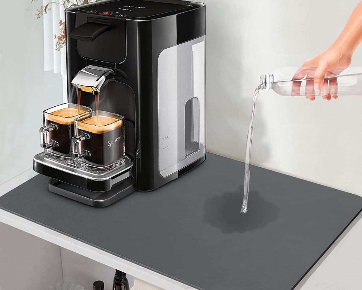 Super Absorbent Drainer Mat under coffee machine on countertop, demonstrating water resistance.