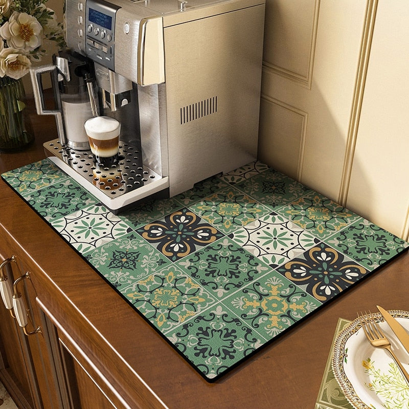 Absorbent kitchen dish drying mat with decorative tile pattern under a coffee maker.